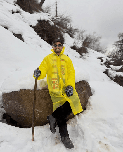 Standing on a snowy mountain in a yellow jacket